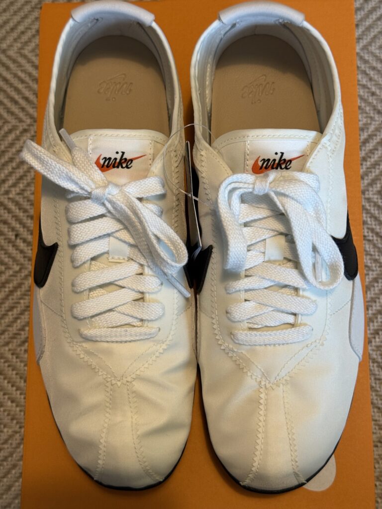 Close-up of the pristine white Nike Moon Shoe and vintage logo tongue