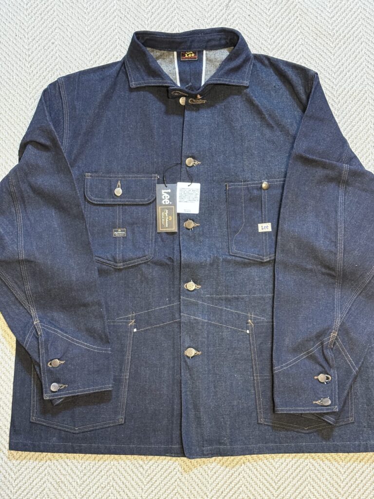 Folded RAILWAYMAN JACKET focusing on the horizontal collar and buttons