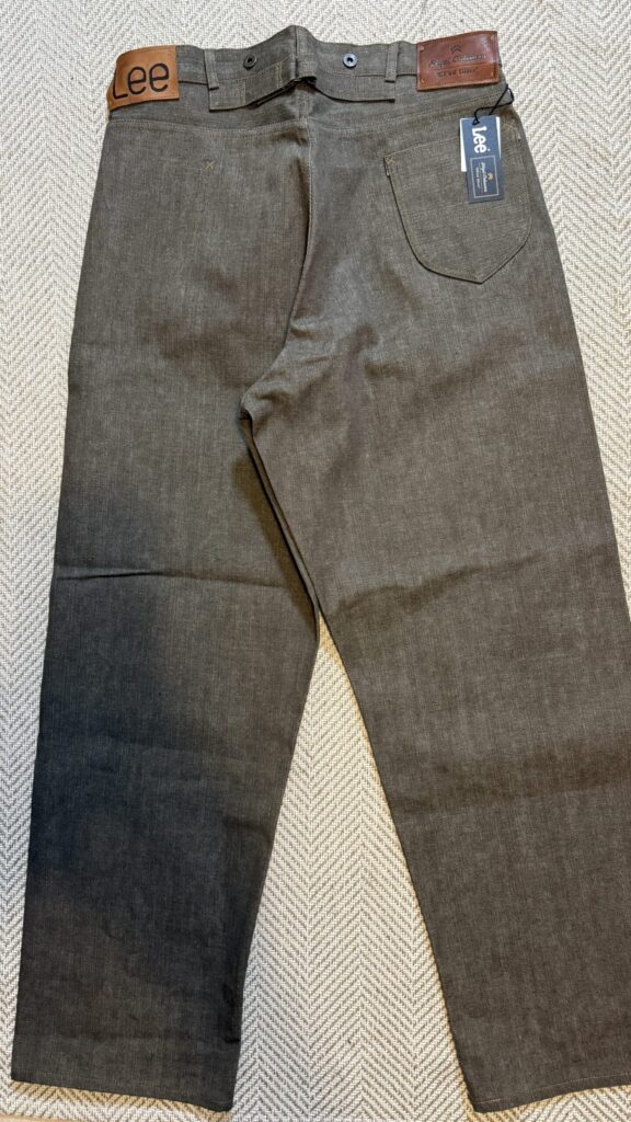 Wide shot of the folded green RODEO CLOWN TROUSERS highlighting the belt loops