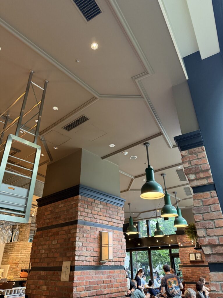 Industrial green pendant lights hanging above the dining area