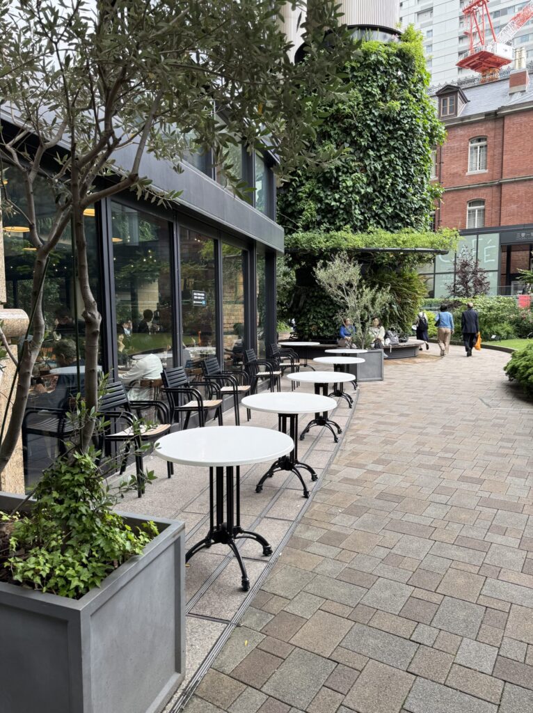 Empty white tables and black chairs on the terrace of A16 TOKYO