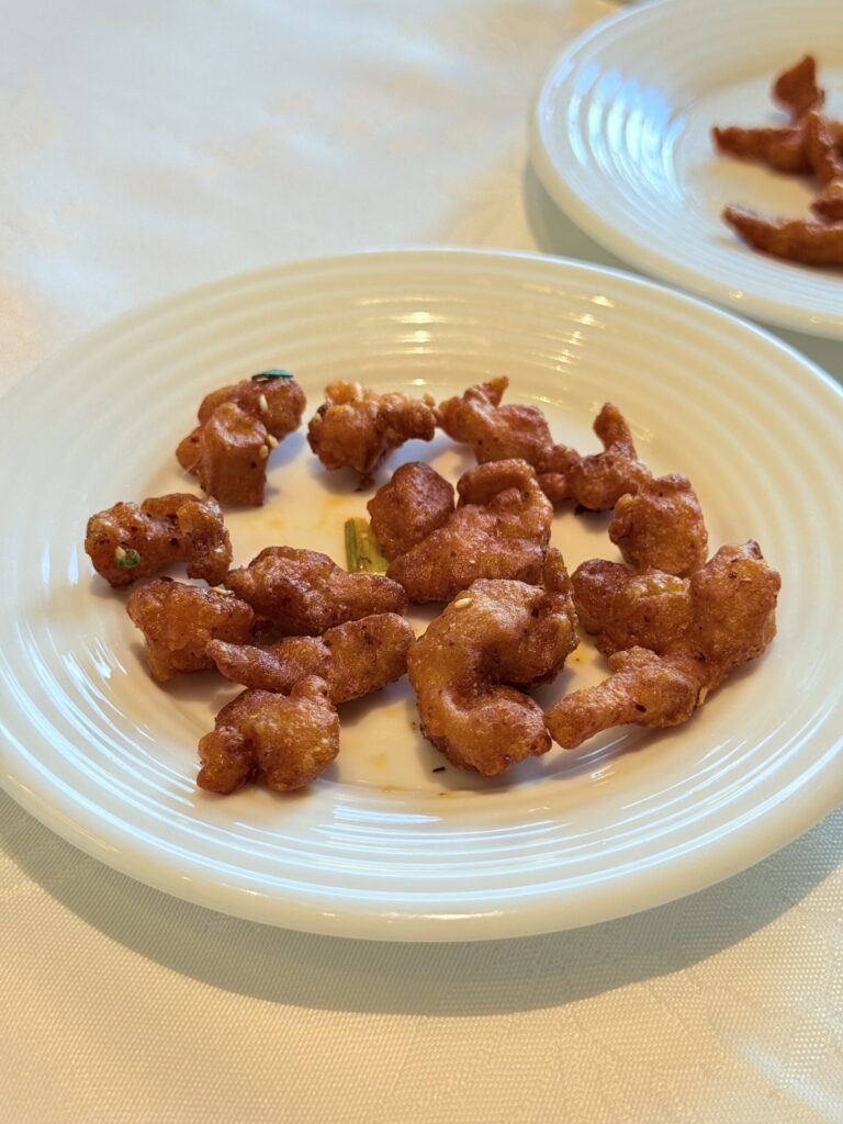 Crispy golden fritters sprinkled with white sesame seeds