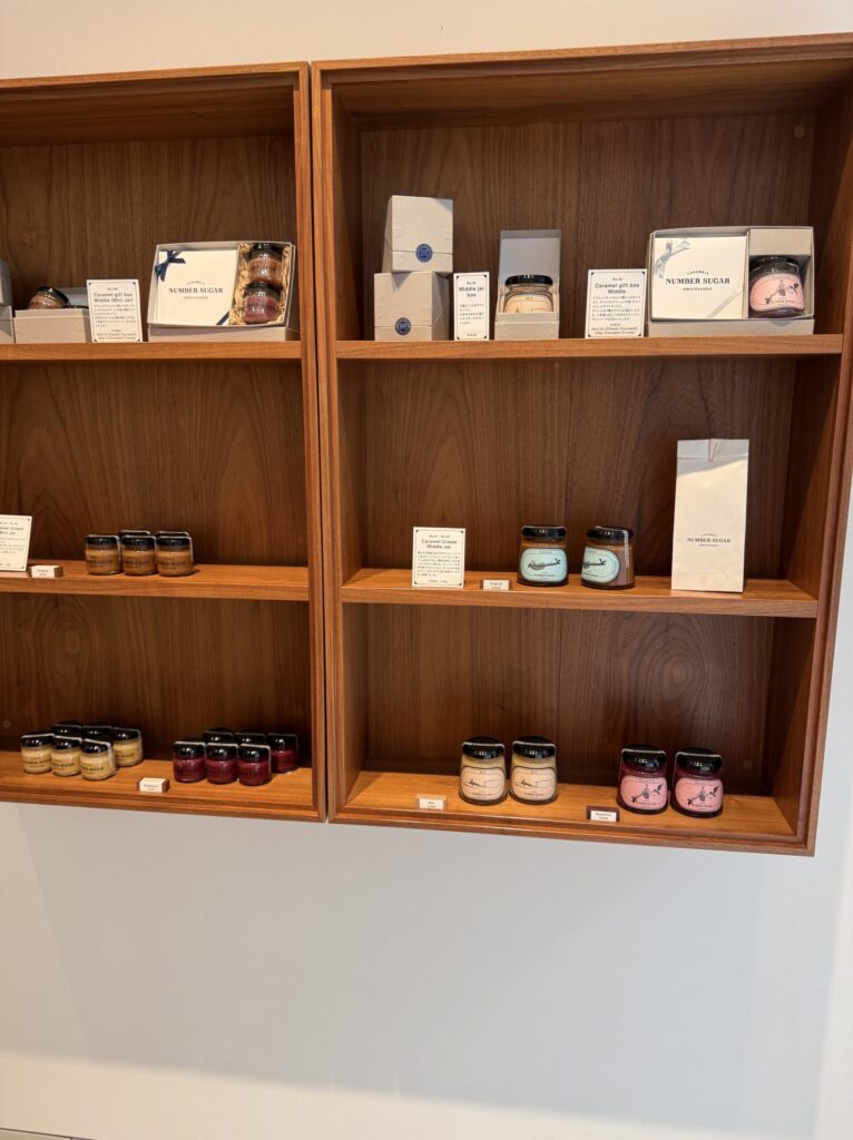 Neatly organized wooden shelves displaying various NUMBER SUGAR packages