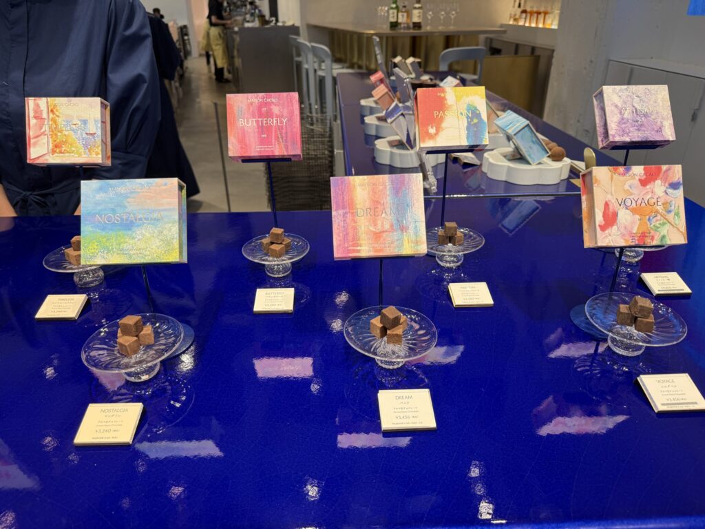 Artistic packages labeled NOSTALGIA, DREAM, and VOYAGE