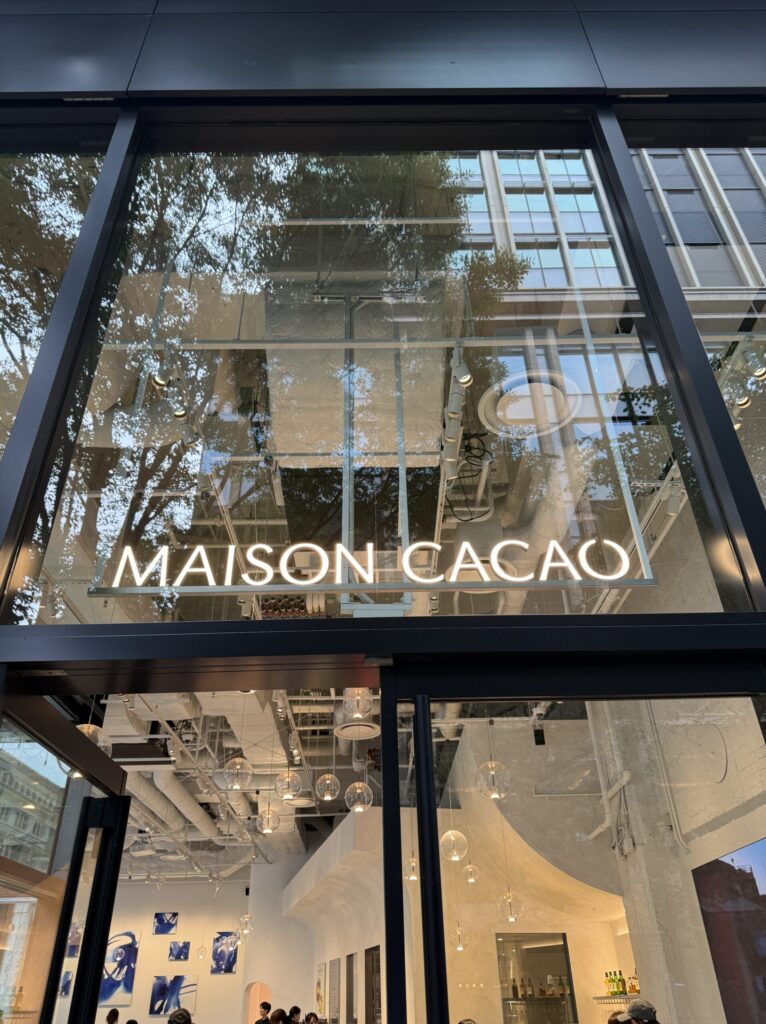 Maison Cacao Marunouchi flagship store entrance with glowing logo