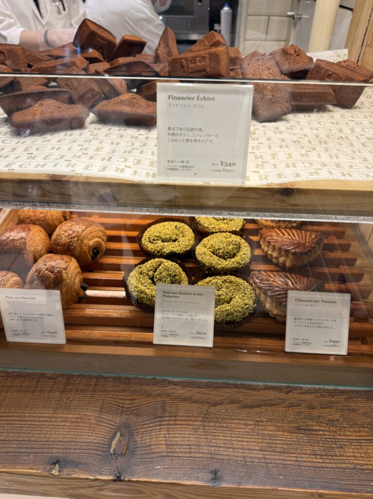 A golden panorama of beautifully stacked financiers and vibrant green pastries