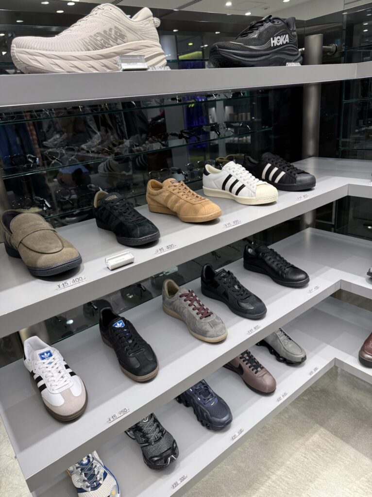 Sneaker display including adidas and HOKA models