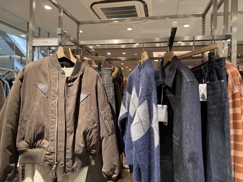 Mixed rack with brown blouson and denim jacket