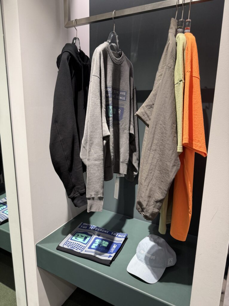 Rack of C.E t-shirts and hoodies