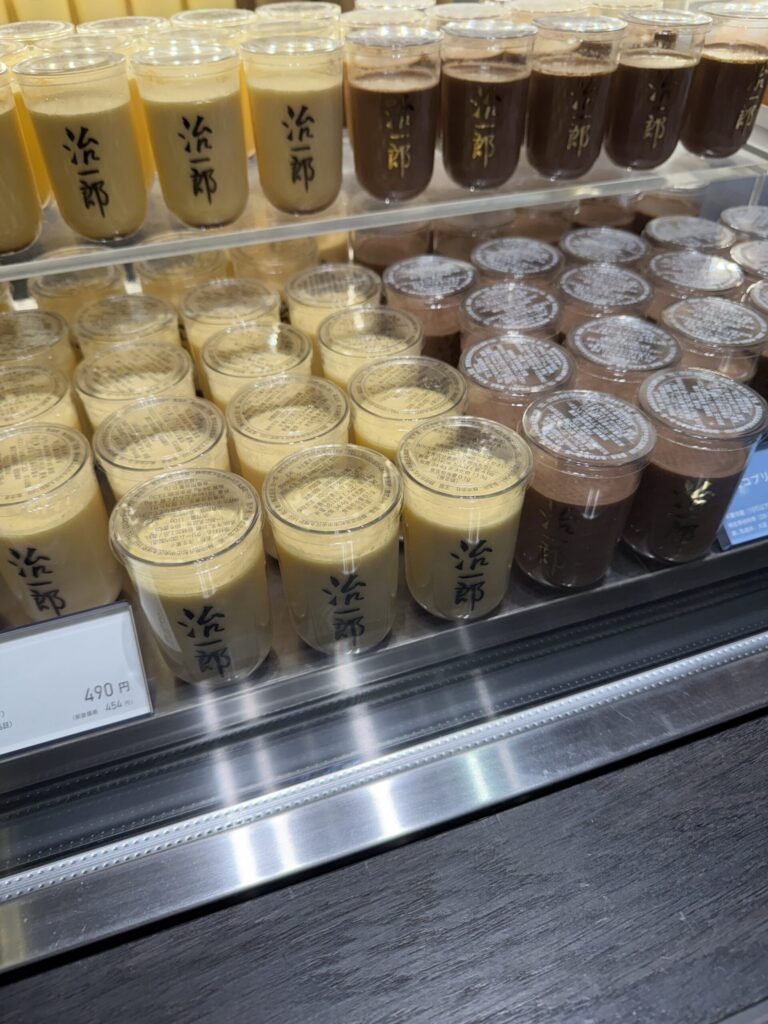 Jiichiro puddings displayed neatly behind a chilled glass case with bold logo prints