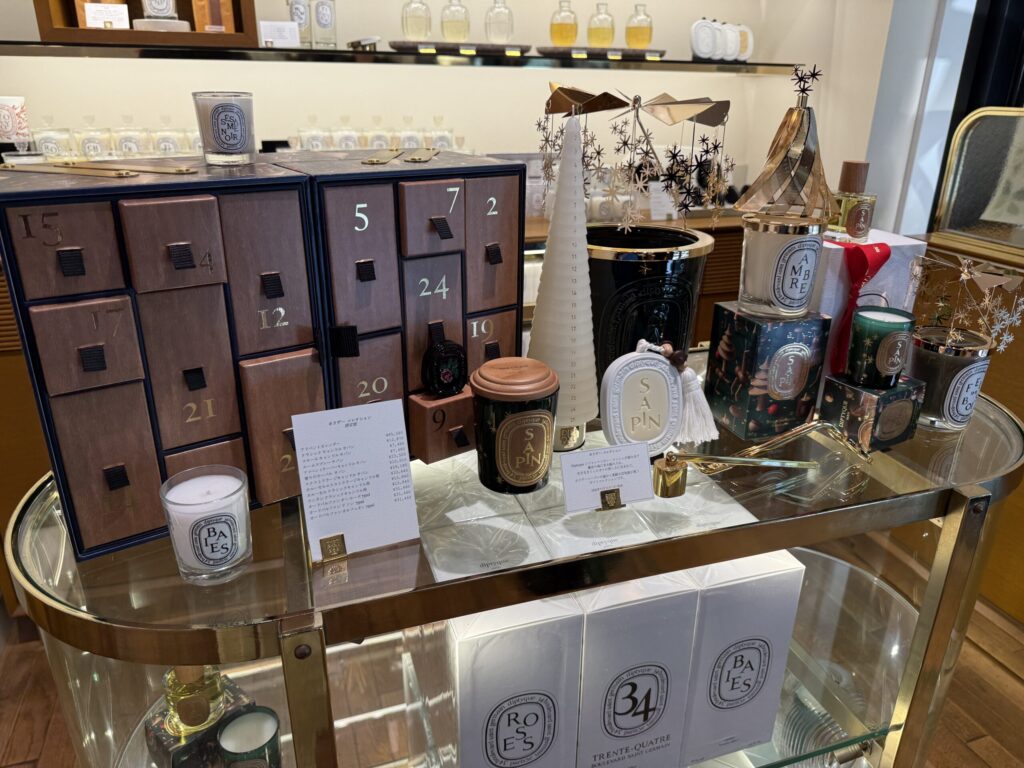 Diptyque store glass showcase featuring the 2026 advent calendar.