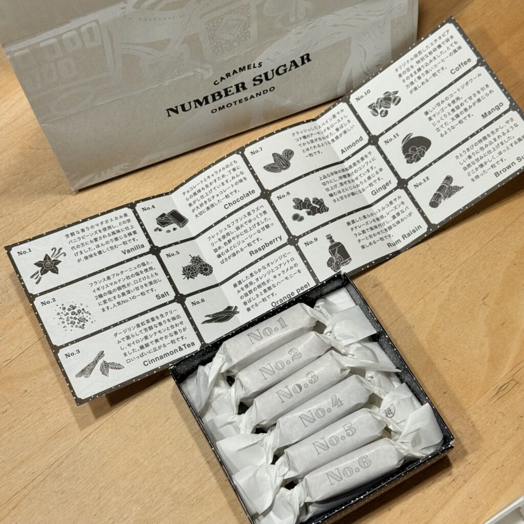 Black box containing caramels alongside a descriptive flavor leaflet