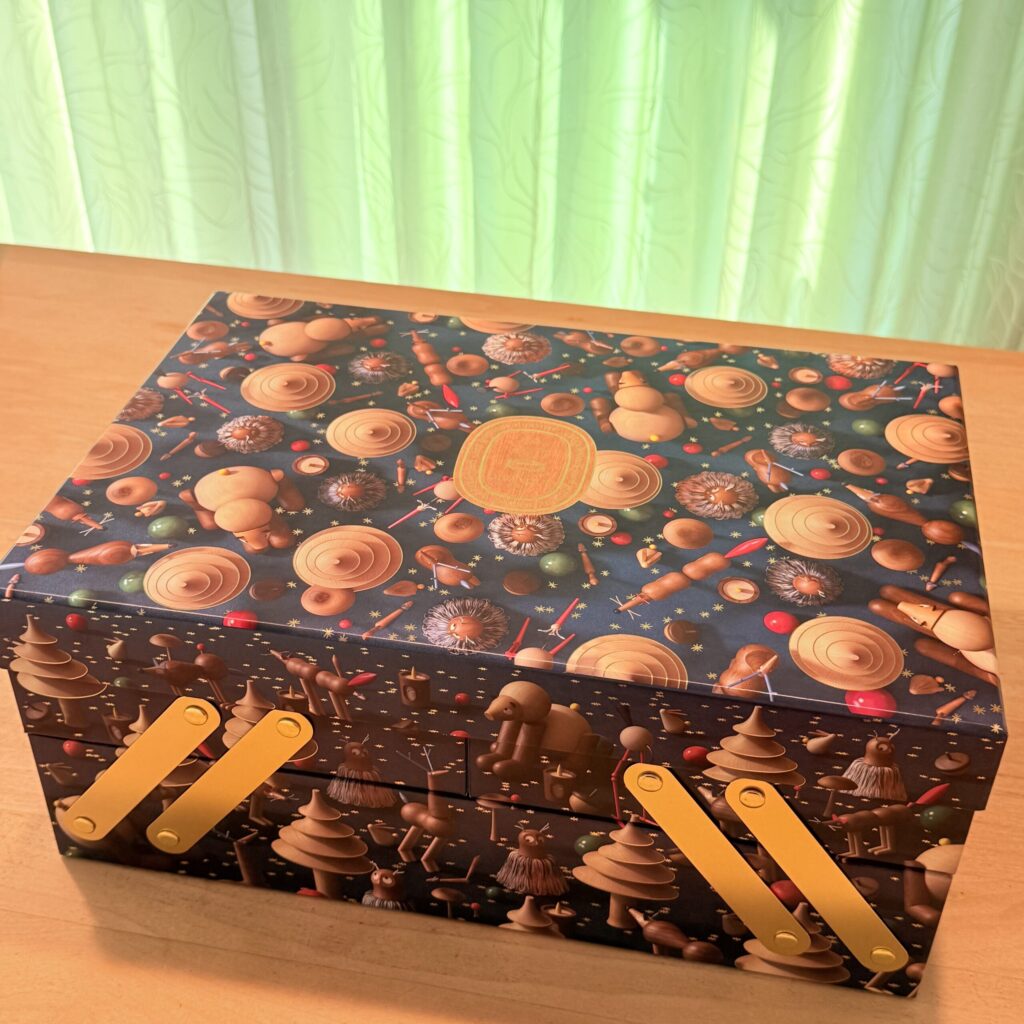 Closed diptyque advent calendar 2026 box with magic forest theme on a wooden table.